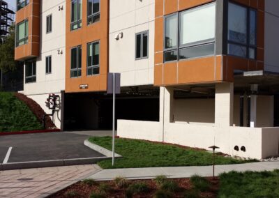 A large apartment building with a parking lot.