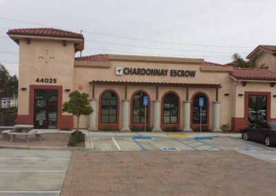 A building with a parking lot in front of it.