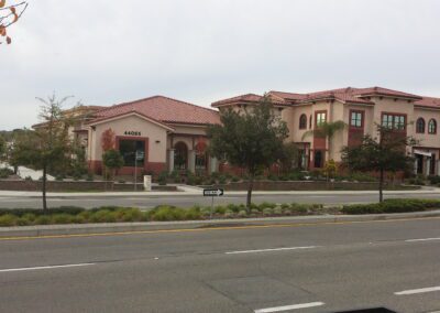 A red brick building on the corner of a street.