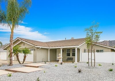 A home with a driveway and palm trees.
