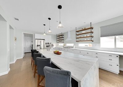 A kitchen with a marble counter top.